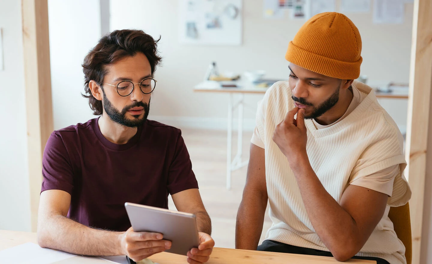 Image of two men contemplating work