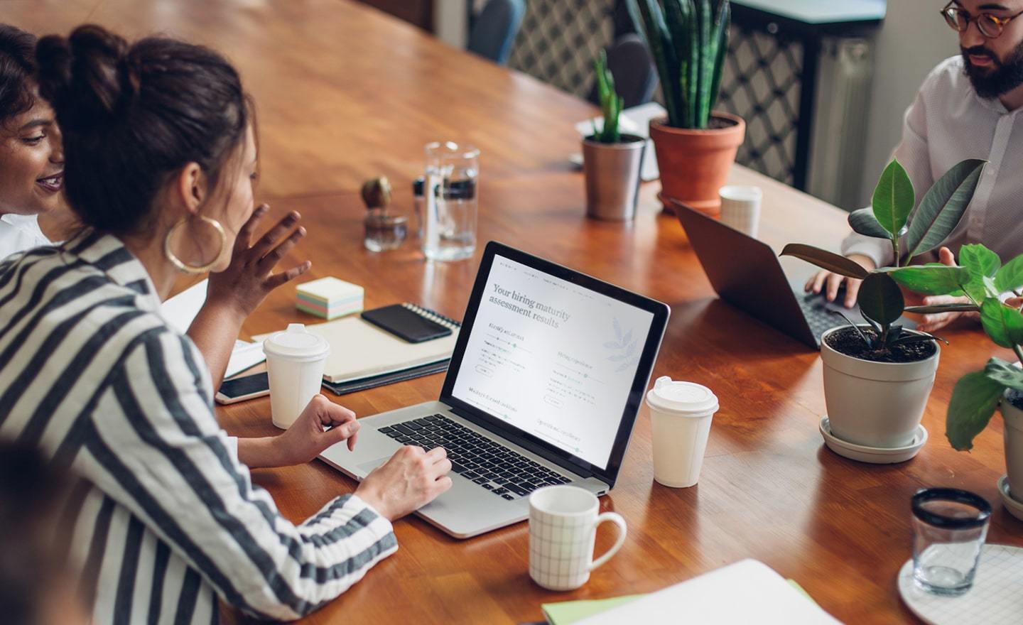 Group-of-coworkers-around-a-conference-table-with-plants.jpg