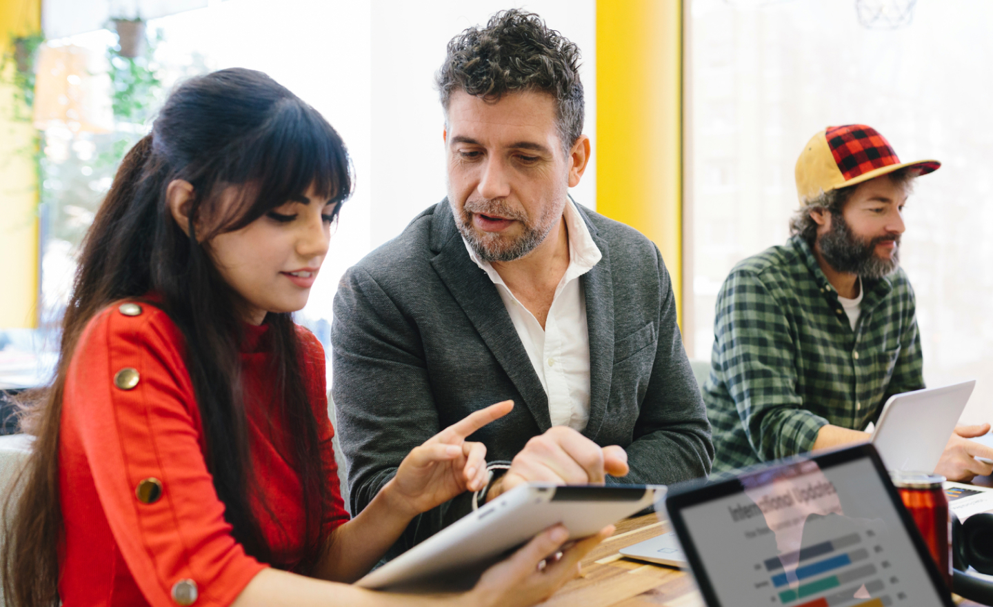 Colleagues-chatting-while-using-tablet-in-office.jpg