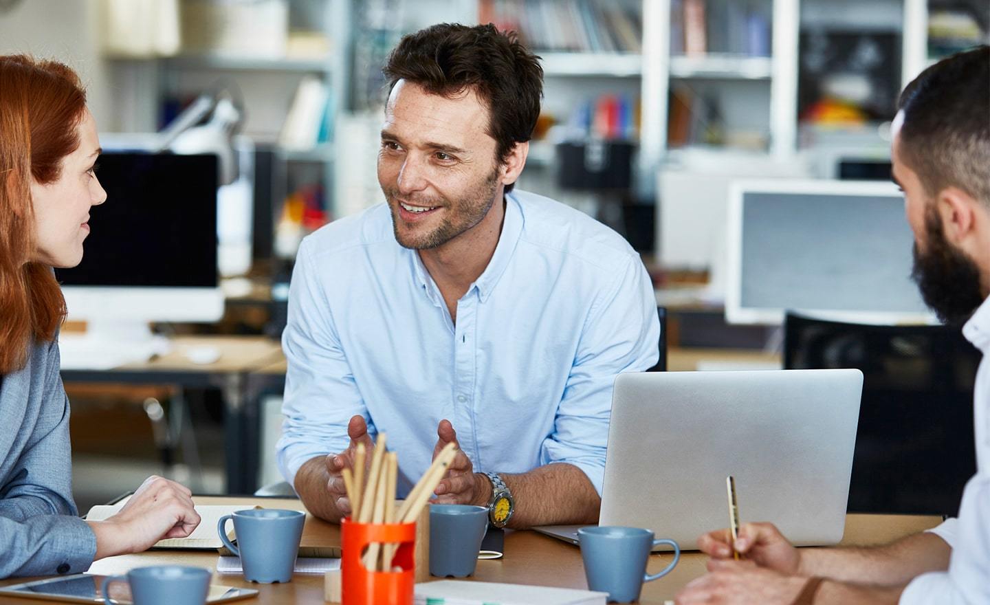 Three-coworkers-having-a-casual-meeting-in-an-open-office.jpg