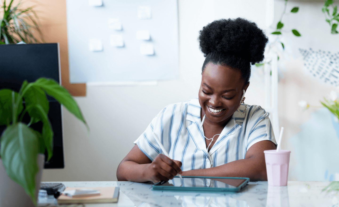 A woman smiling while using her iPad